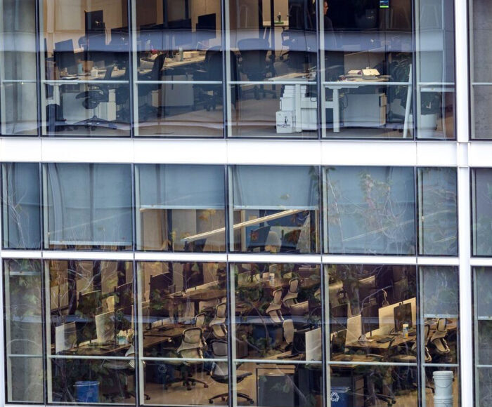 Closeup of wall of offices in a glass office building